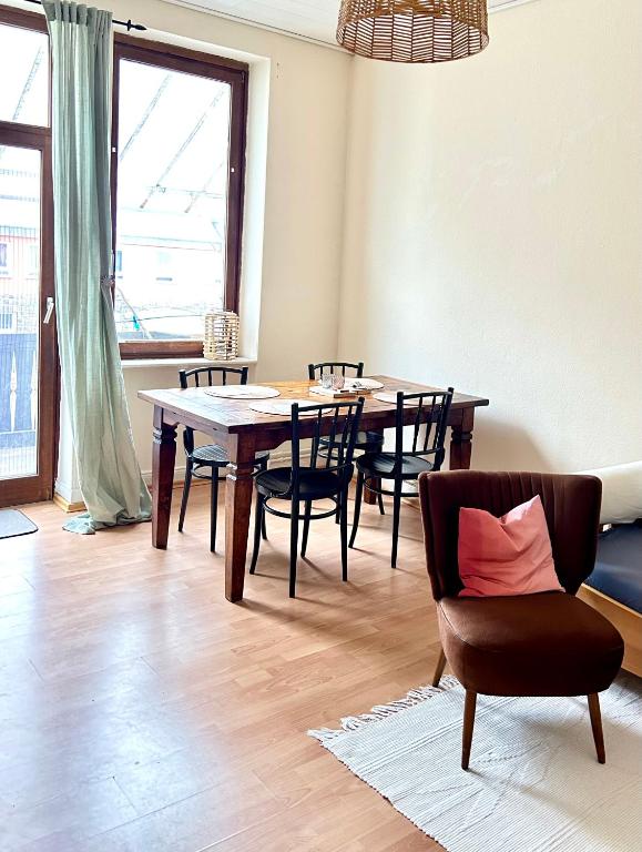 a dining room with a wooden table and chairs at Forest Charm and Gems in Idar-Oberstein