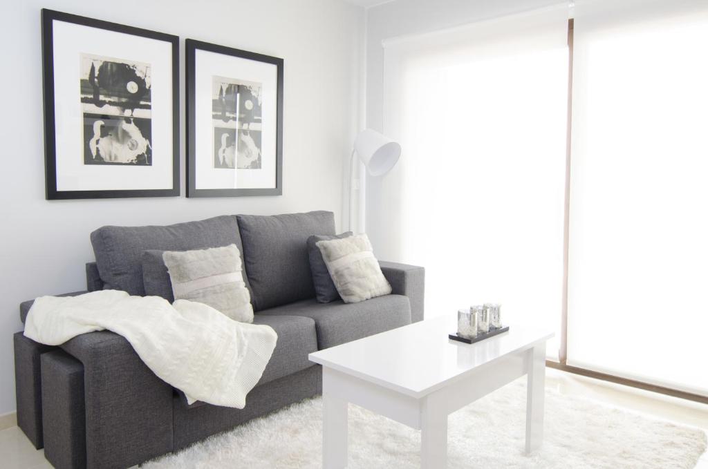 a living room with a couch and a table at Mar de Pulpí Costa de Almeria by Mar Holidays in San Juan de los Terreros