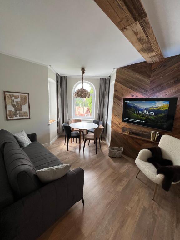 a living room with a couch and a table at Apartament Villa Nelly in Szklarska Poręba