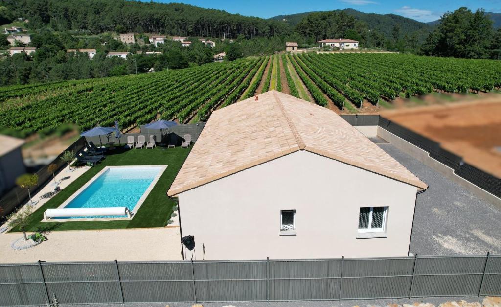 an overhead view of a house with a swimming pool and a vineyard at En Ardèche Villa de vacances l'Olympe climatisée avec sa piscine privée et chauffée in Joyeuse