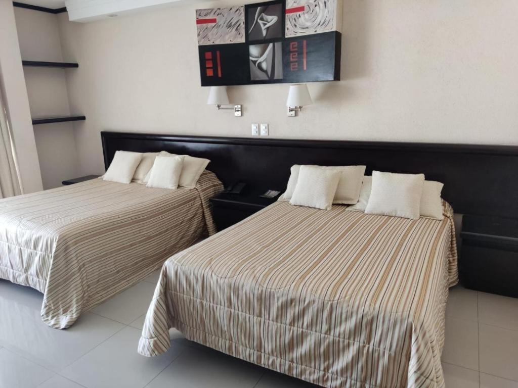Postel nebo postele na pokoji v ubytování Hotel Mary Celaya