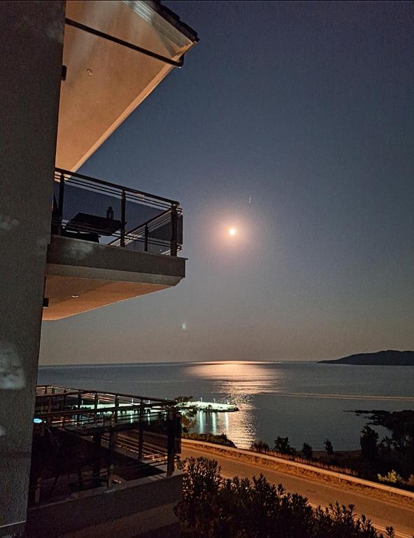 a view of the ocean at night with the moon at Sarti Thea in Sarti
