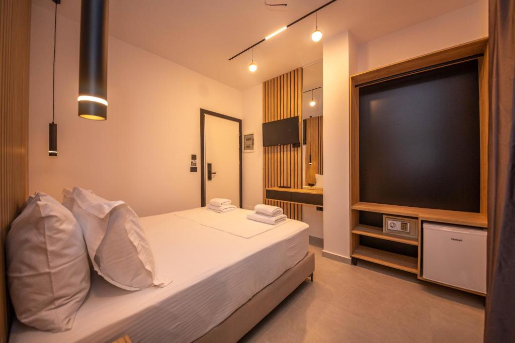 a bedroom with a bed with a flat screen tv at Vila Olserd Shehu in Ksamil