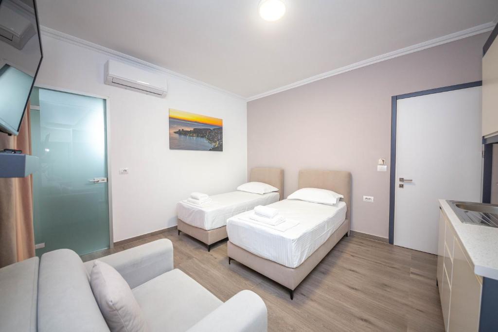 a living room with two beds and a couch at Vila Olserd Shehu in Ksamil