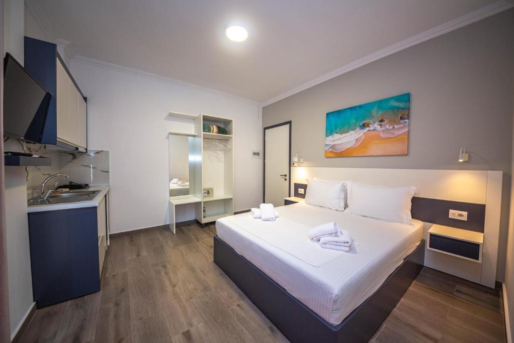 a hotel room with a bed and a sink at Vila Olserd Shehu in Ksamil