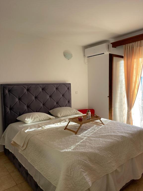 a bedroom with a large bed with a table on it at Apartmani Gazivode in Budva