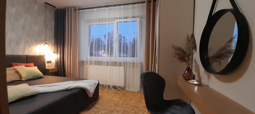 Ένα ή περισσότερα κρεβάτια σε δωμάτιο στο Villa Port Apartamenty