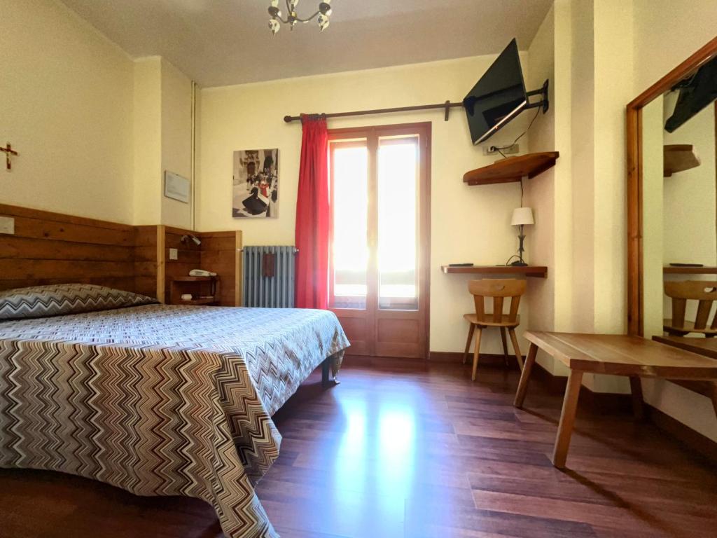 Postel nebo postele na pokoji v ubytování Hotel Garnì Mille Pini