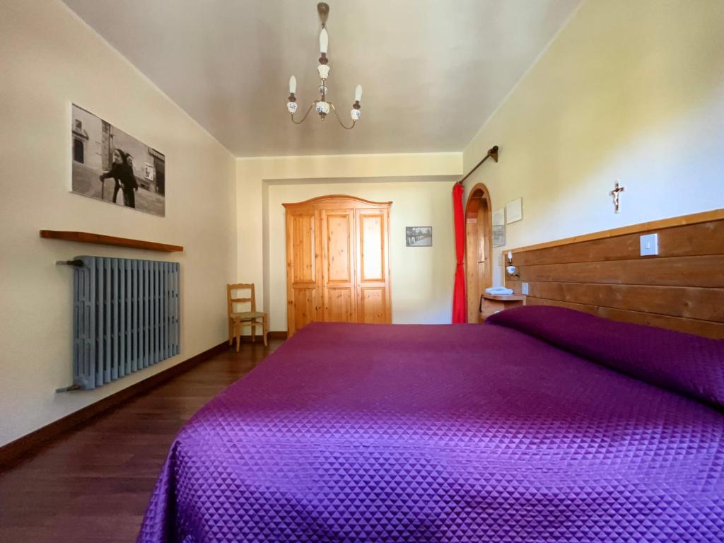Postel nebo postele na pokoji v ubytování Hotel Garnì Mille Pini