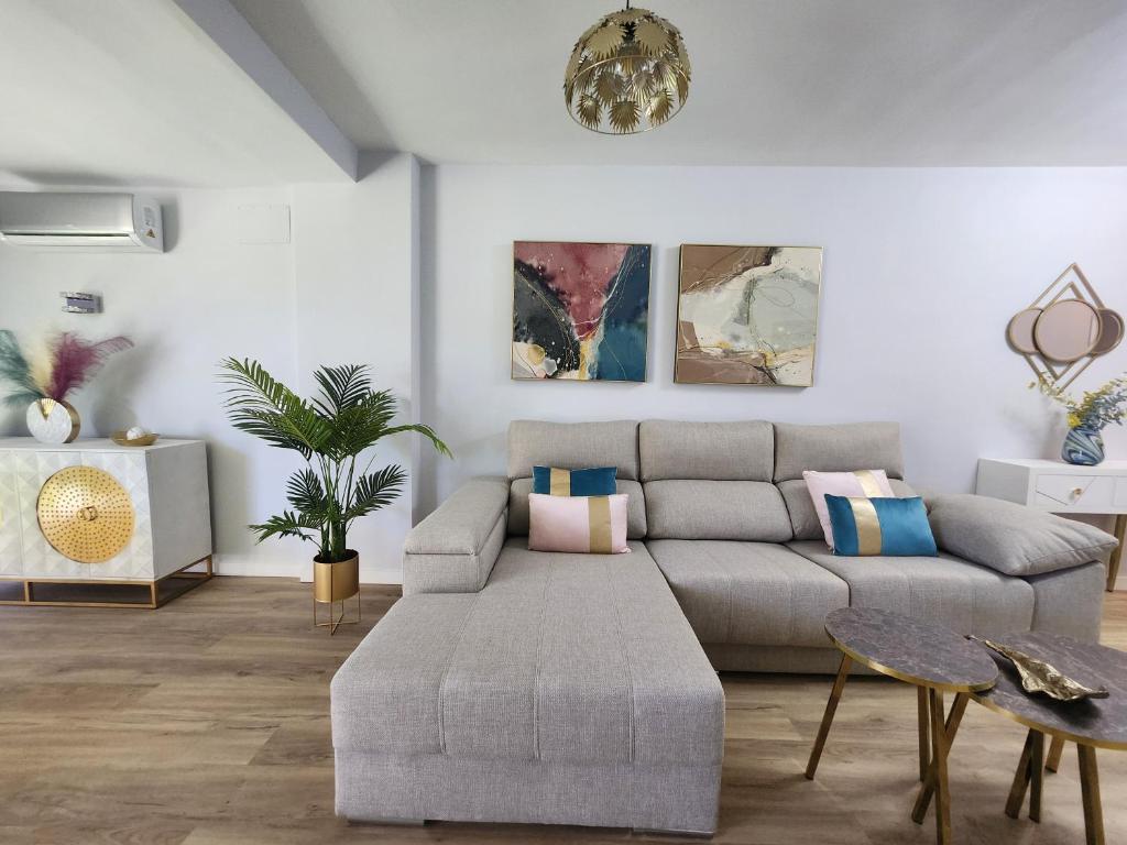 a living room with a couch and a table at ANSA Beach Apartments - Cabopino, Marbella - Garden level in Cabopino
