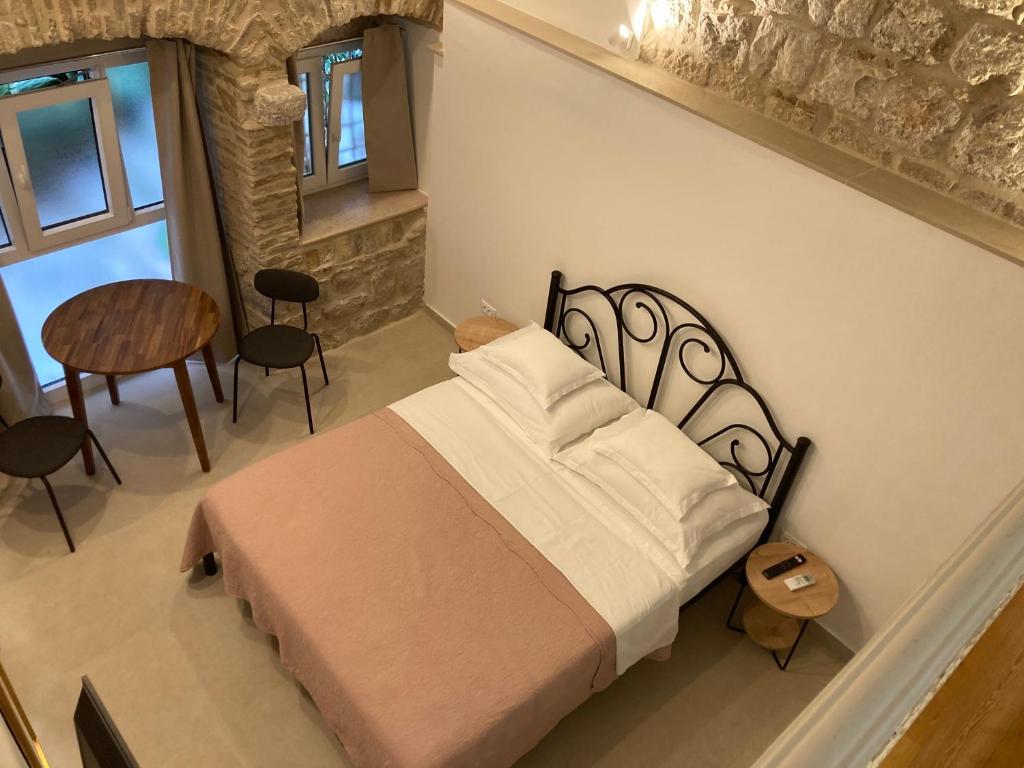 a bedroom with a bed and a table and chairs at studio apartment Vicelic in Dubrovnik