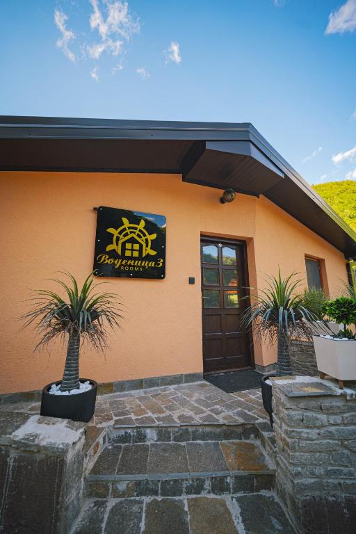 a building with a sign on the side of it at Vodenica 3 Rooms in Duračka Reka