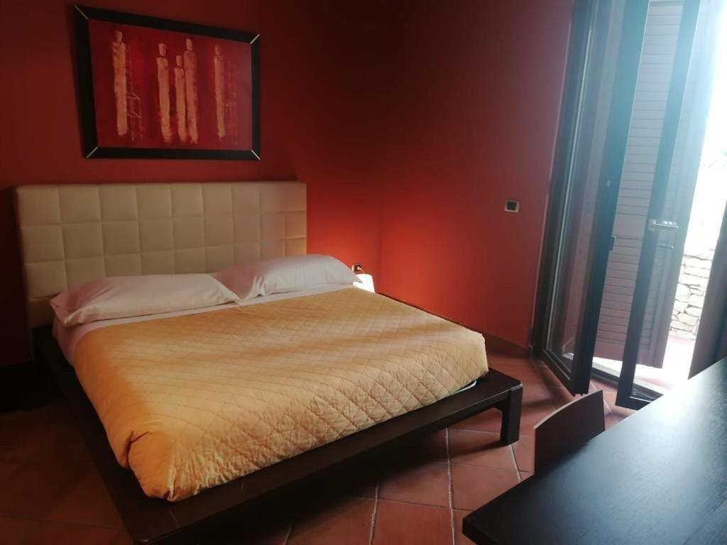Postel nebo postele na pokoji v ubytování Maglioferro Residence