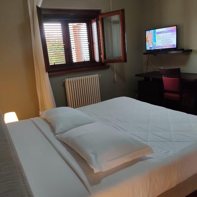 Postel nebo postele na pokoji v ubytování Maglioferro Residence
