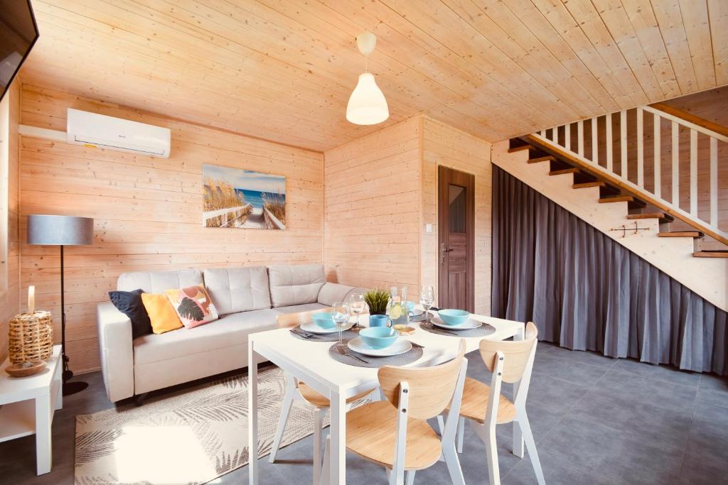a living room with a table and a couch at Rafa Międzywodzie in Międzywodzie