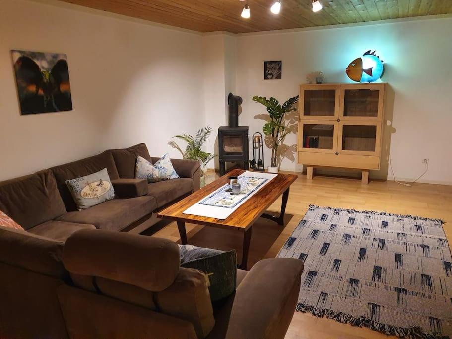 a living room with a couch and a coffee table at Kellergeschosswohnung mit Aussicht und Terasse in Strand