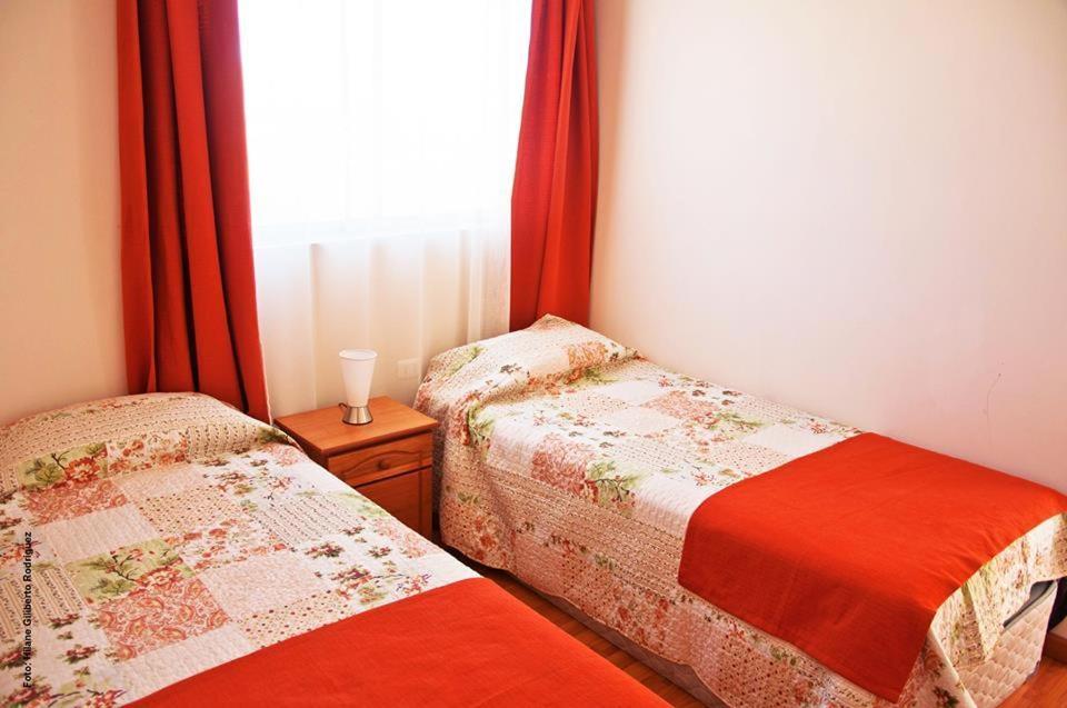 En eller flere senge i et værelse på Hostal Alto Algarrobal