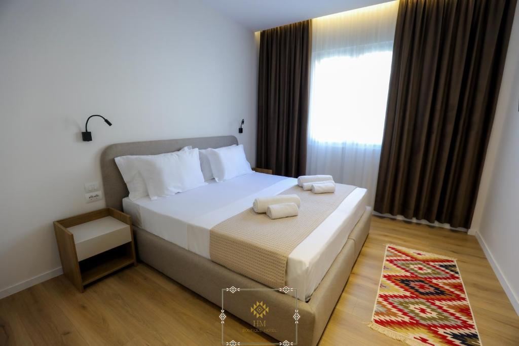 Postel nebo postele na pokoji v ubytování HM Boutique Hotel