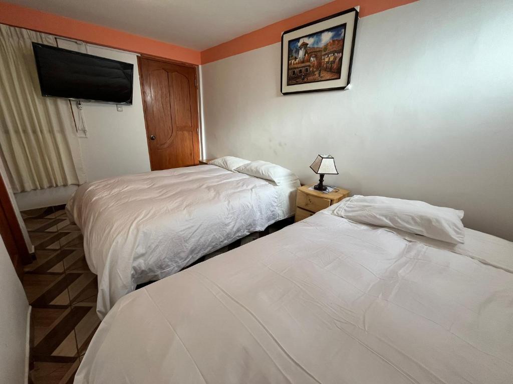 Postel nebo postele na pokoji v ubytování Hostal Apu Qhawarina