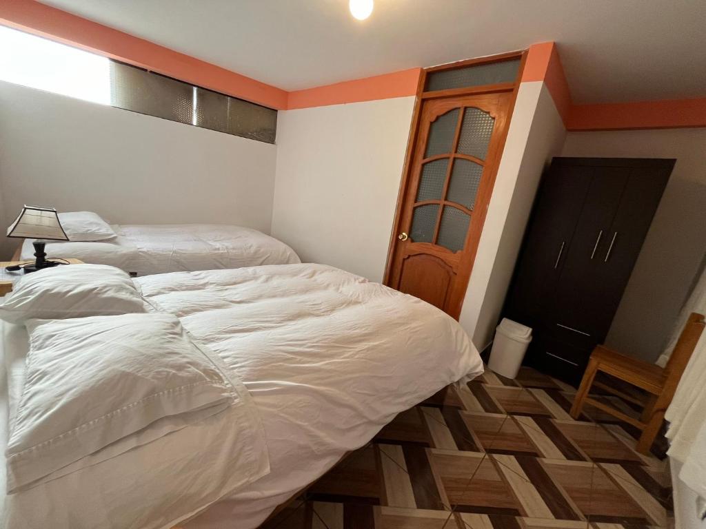 Postel nebo postele na pokoji v ubytování Hostal Apu Qhawarina