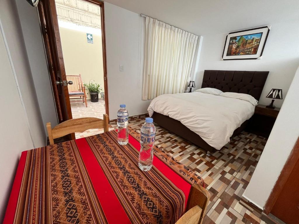 Postel nebo postele na pokoji v ubytování Hostal Apu Qhawarina
