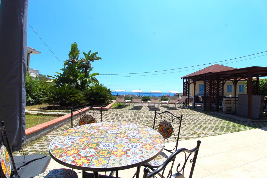 a table and chairs sitting on a patio at La Pace, il Sole, il Mare - Sanremo Casa Indipendente vista mare, posto auto privato, ampio spazio esterno attrezzato, a pochi minuti dalle spiagge in Sanremo