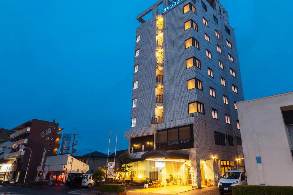 a tall building with lights on the side of it at City Hotel Air Port in Prince in Izumi-Sano