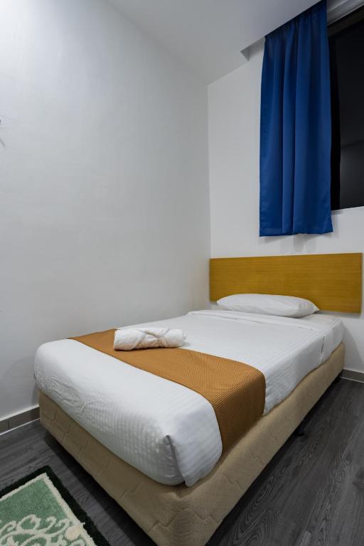 Postel nebo postele na pokoji v ubytování Nunuk Ragang Hotel