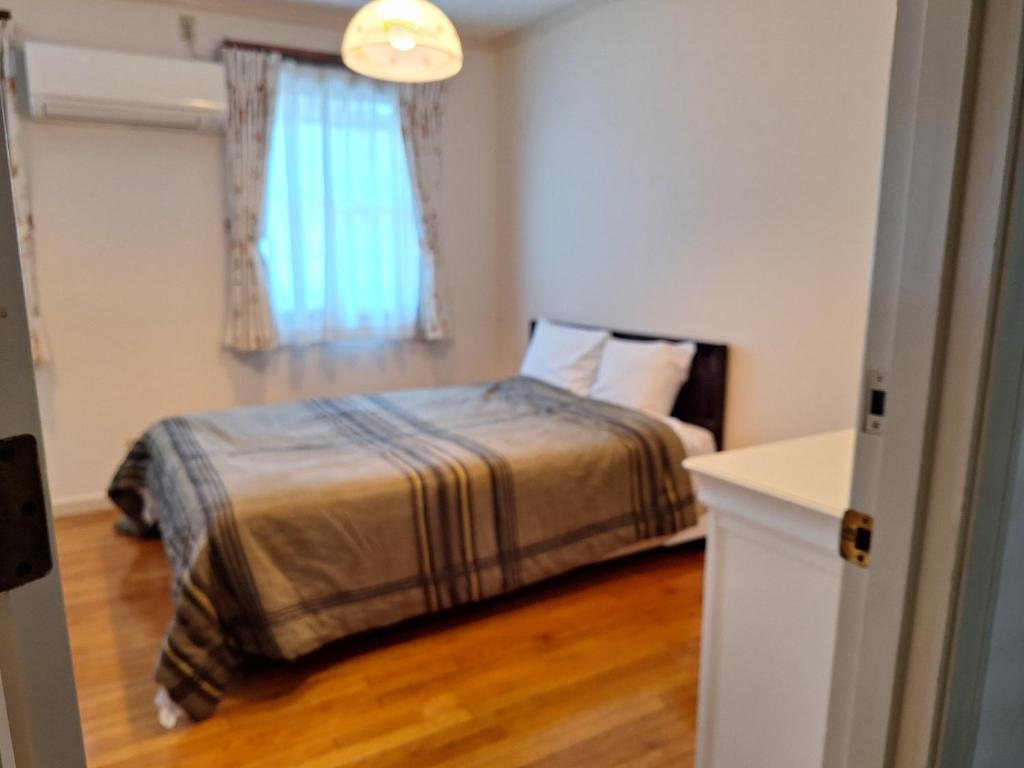 Postel nebo postele na pokoji v ubytování Urban Residence Ikebukuro East