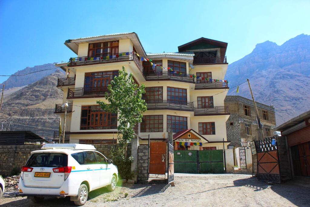 a white car parked in front of a building at Hotel Spiti Heritage in Kaza