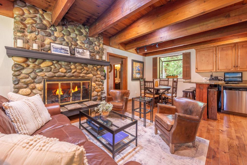 a living room with a stone fireplace in a house at Tahoe City 4BR 4 Full Bathroom Home Near Palisades Close to Town in Tahoe City