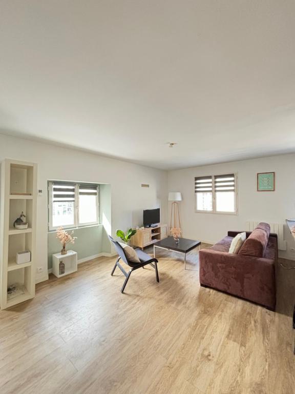 a living room with a couch and a table at Appartement duplex cosy Saint Servan centre in Saint Malo