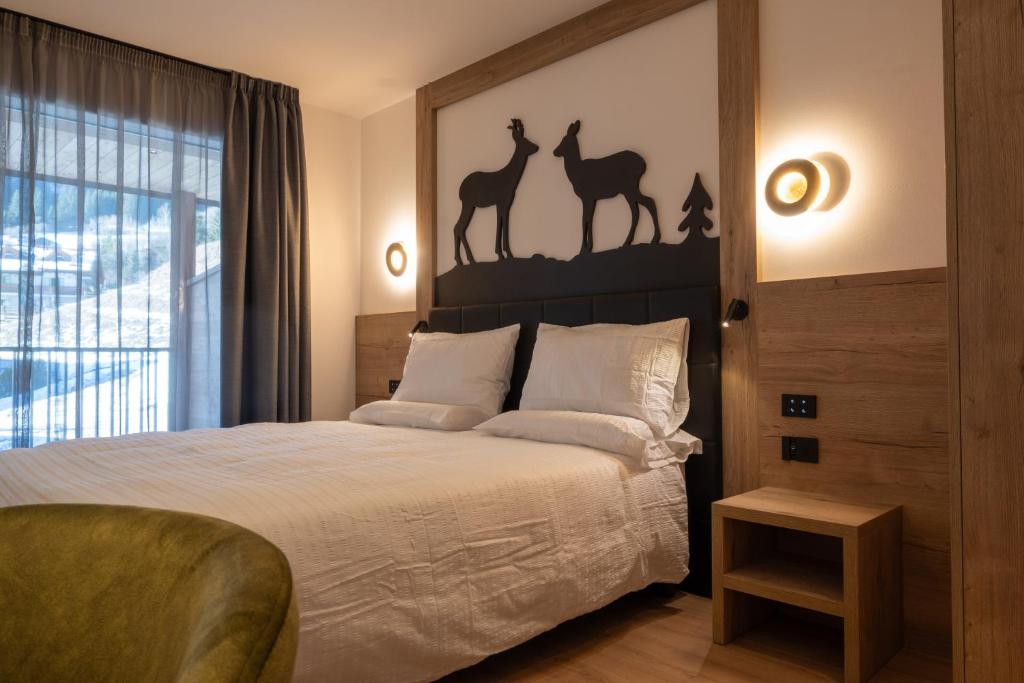 Postel nebo postele na pokoji v ubytování Monza Dolomites Hotel