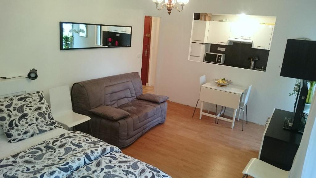 Cette chambre comprend un lit, un canapé et une table. dans l'établissement le saphir, à Aix-les-Bains