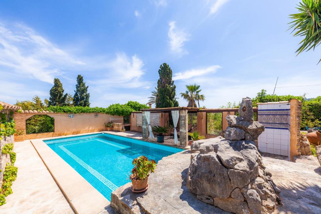 a swimming pool in a yard with a house at Individual Guesthouse Mallorca in Son Macia