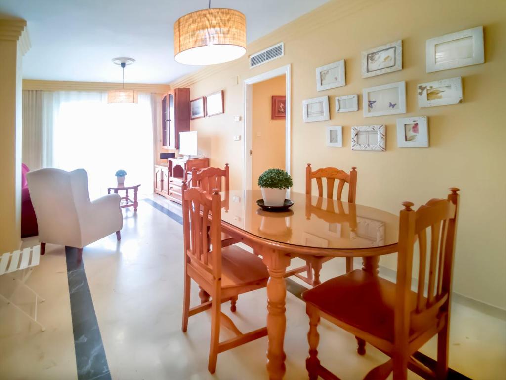 a dining room with a wooden table and chairs at Banana Beach in Marbella