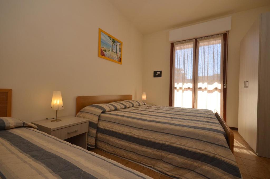 A bed or beds in a room at Residence Valbella