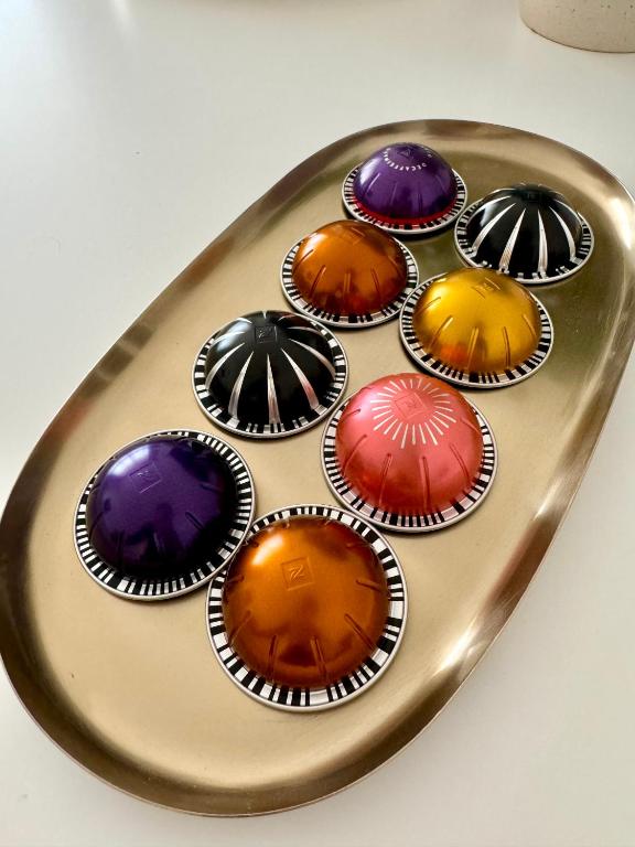 a tray of cupcakes with different colored at Feel Boutique Rooms in Oristano