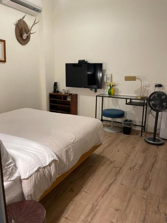 Postel nebo postele na pokoji v ubytování 泰森會館