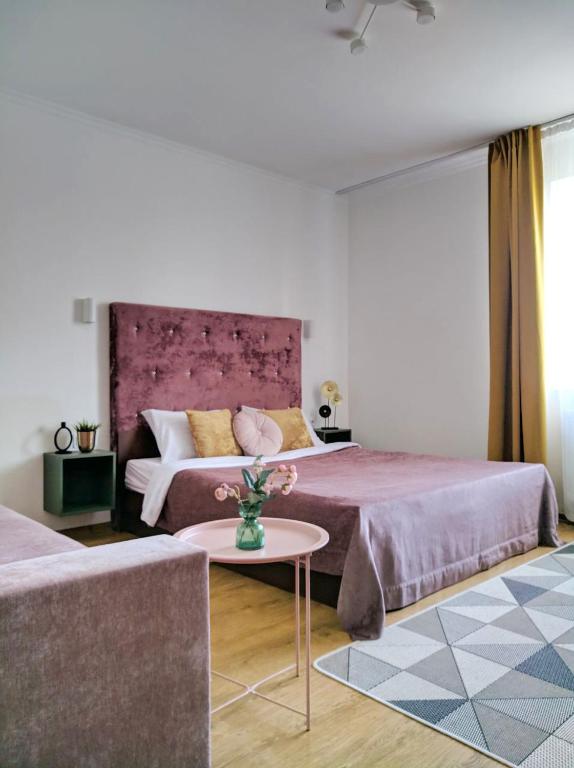 a hotel room with two beds and a table at Best One Room Apartments in Mukacheve