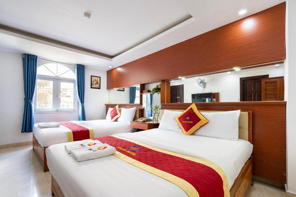 Ένα ή περισσότερα κρεβάτια σε δωμάτιο στο Value Hotel
