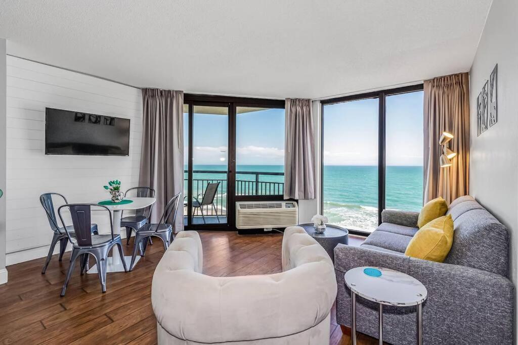 a living room with a view of the ocean at Pristine Oceanfront King Suite Best Layout in Bldg 806 in Myrtle Beach