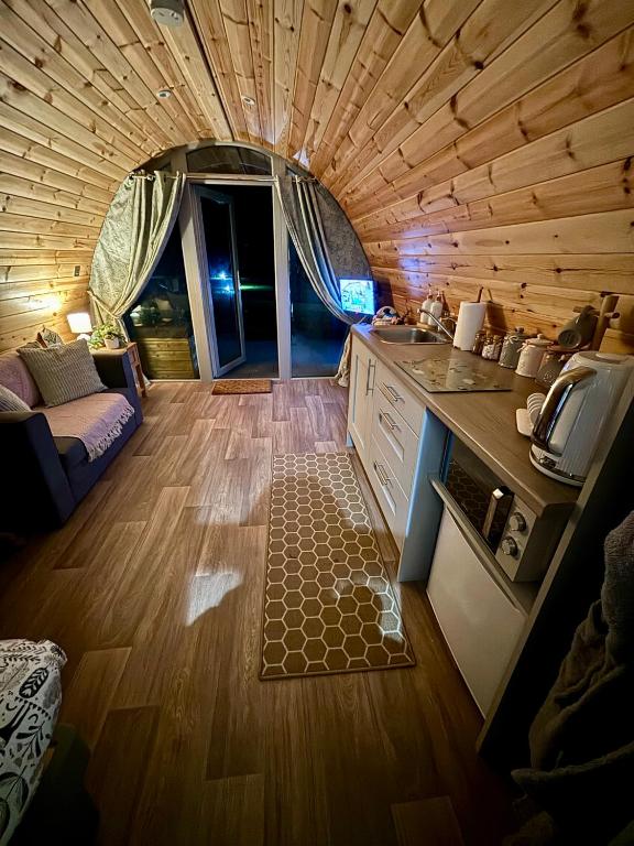 a small kitchen and living room in a tiny house at Knockmany View Glamping in Augher
