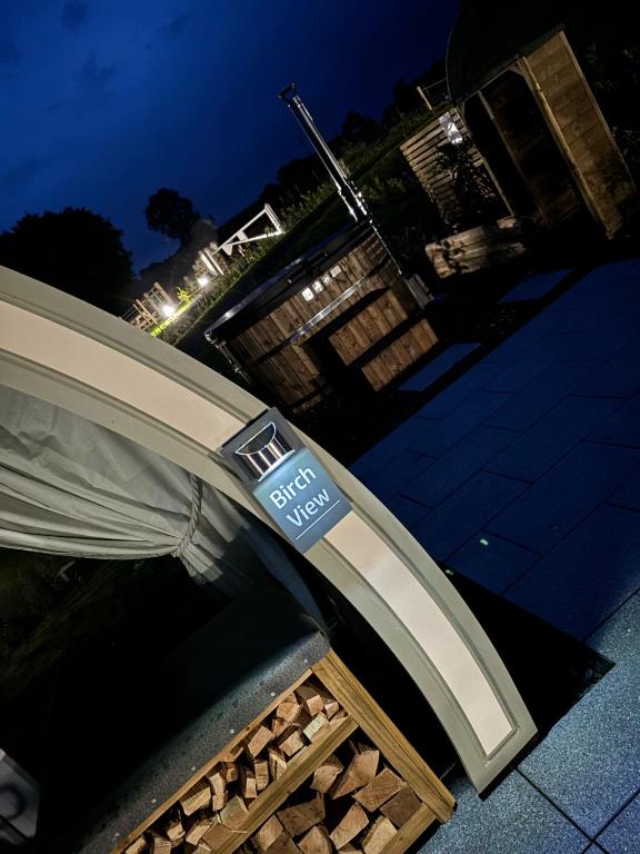 a building with a sign on top of a bench at Knockmany View Glamping in Augher