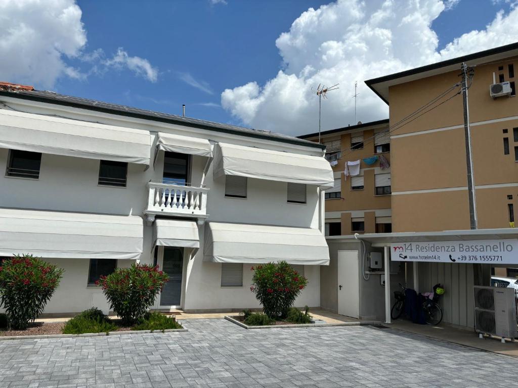 a building with white awnings on the side of it at M14 RESIDENZA BASSANELLO in Padova