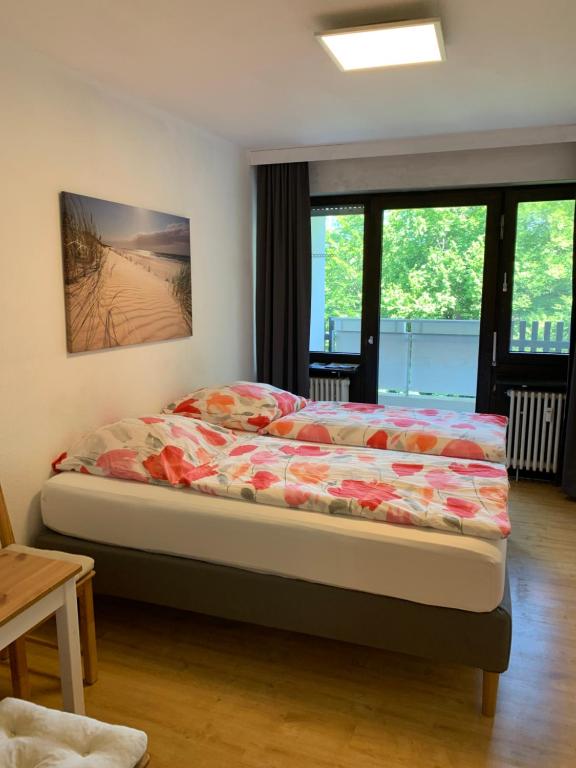 a bedroom with a bed in a room with windows at Panoramahaus 5105 in Bad Reichenhall