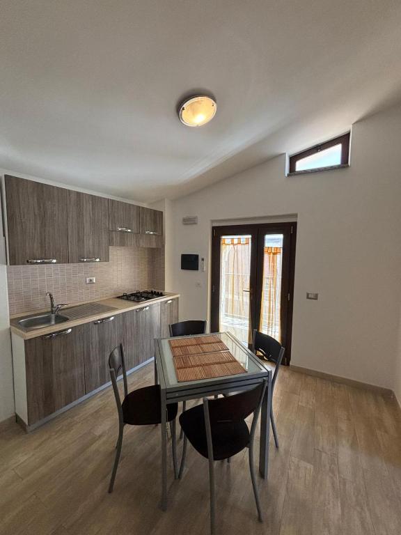 a kitchen and dining room with a table and chairs at Fraicol in Santa Domenica