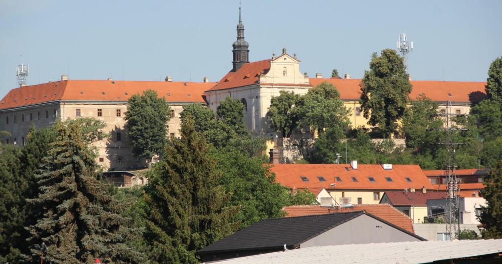 a view of a city with a building and trees at Guest House KRISTI in Tuchoměřice