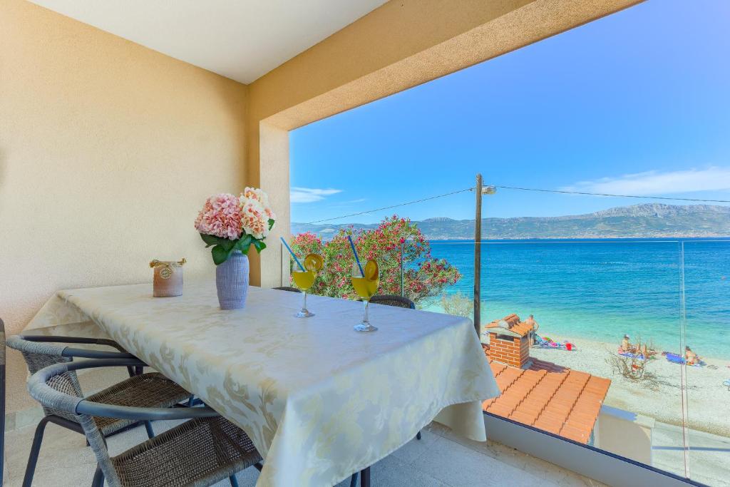 a dining room with a table and a view of the ocean at Villa ARIJANA - LAVANDA in Slatine