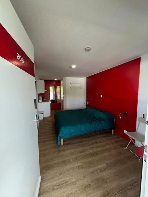 une chambre avec un lit vert dans un mur rouge dans l'établissement JOIA Bassin d'Arcachon - NOTRO 208, à La Teste-de-Buch